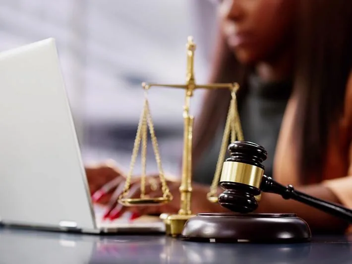 Legal education workspace with scales of justice, gavel and laptop