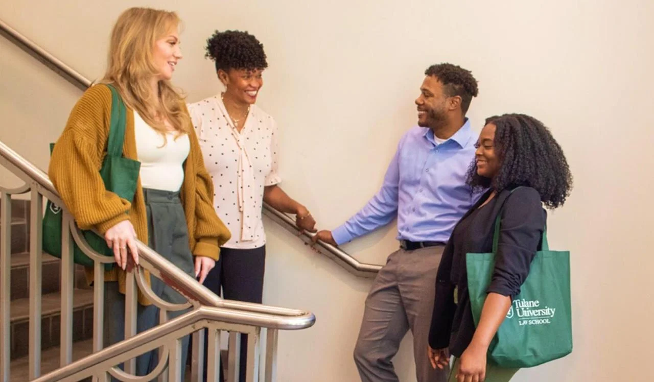 Law school students and mentors talking on a stairway