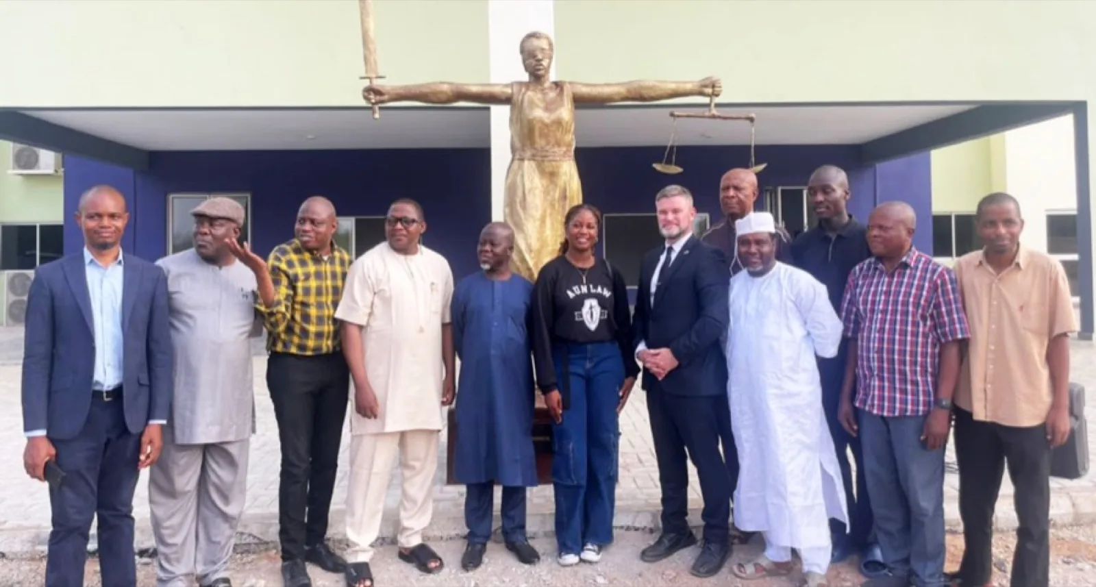 AUN Law Week participants standing by a statue of justice